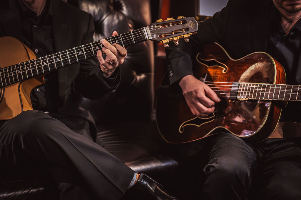 Two acoustic guitars mid-strum