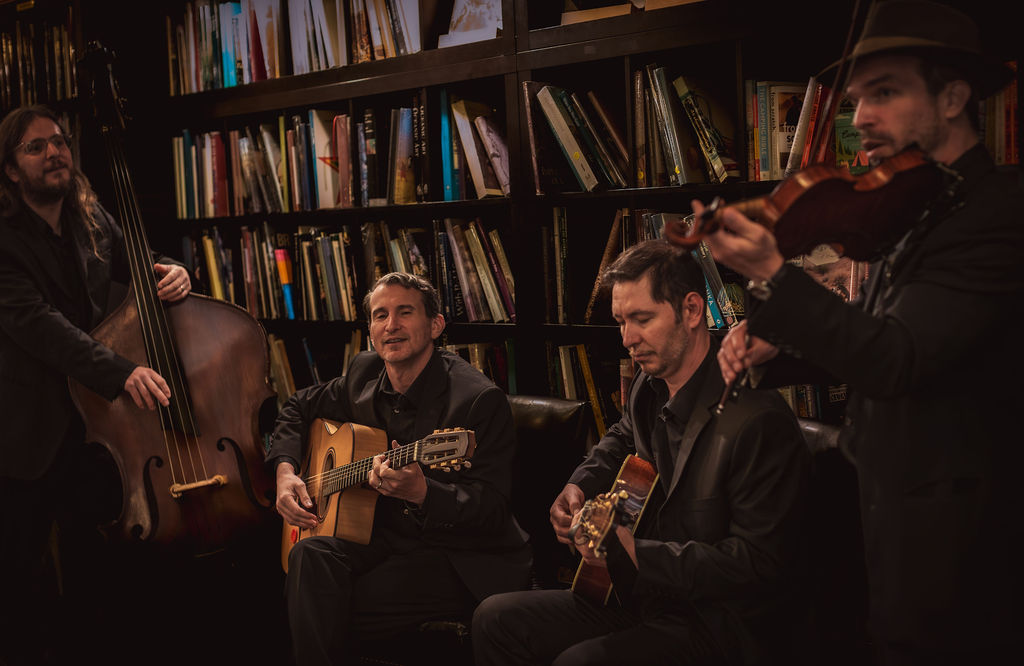 Quartet performing in front of a bookshelf